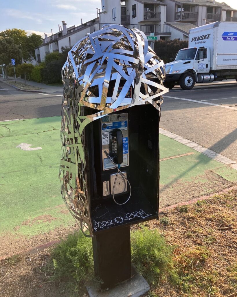 Payphone wrapped in metal bands
